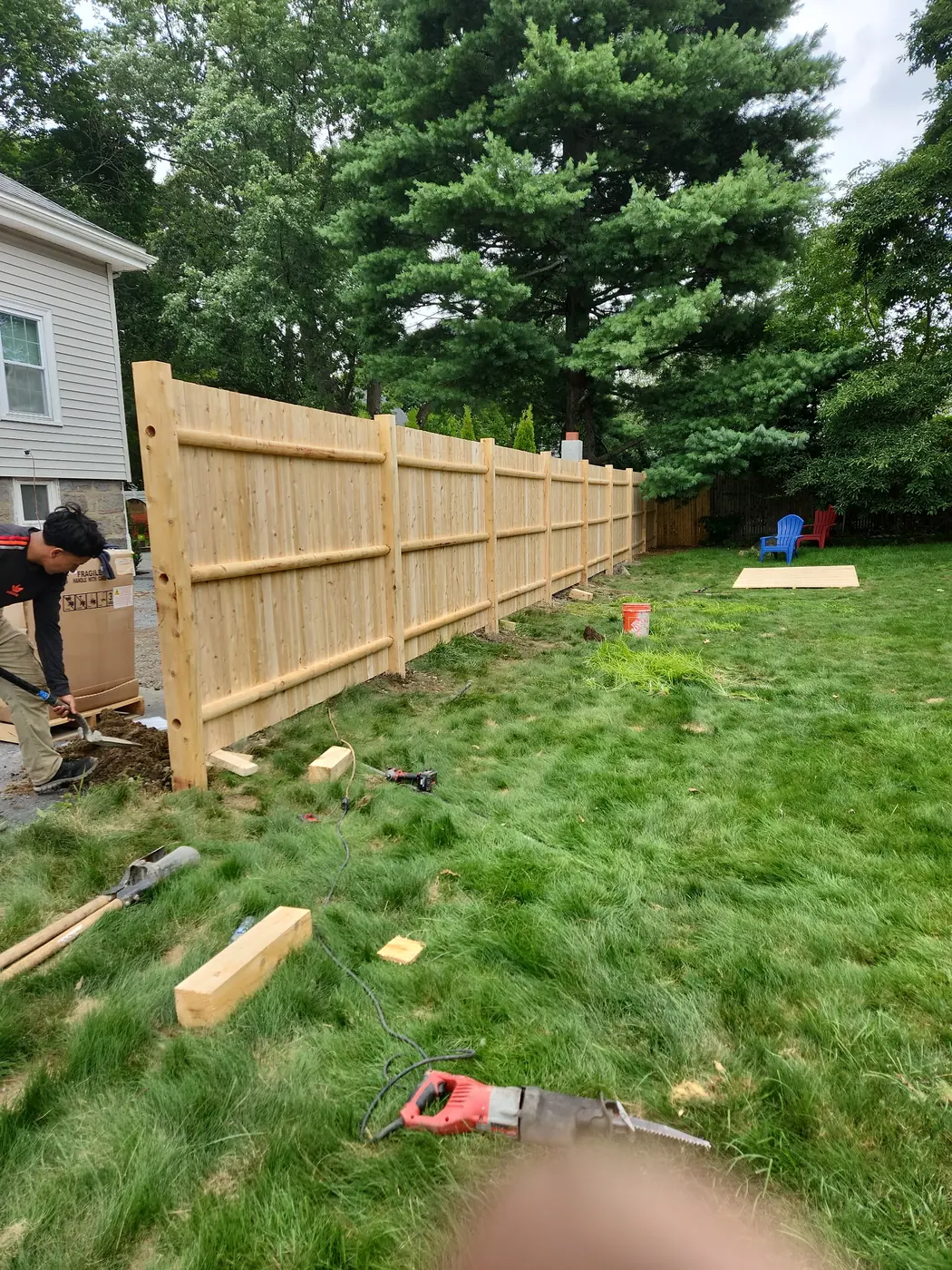 Cedar stockade privacy fence with rounded wood rails