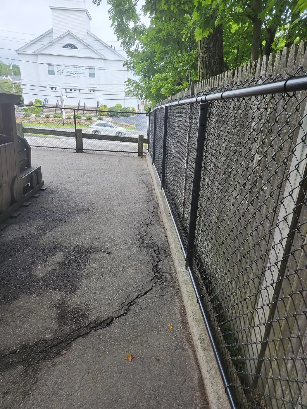 Black chain-link corner section enclosing a daycare play yard