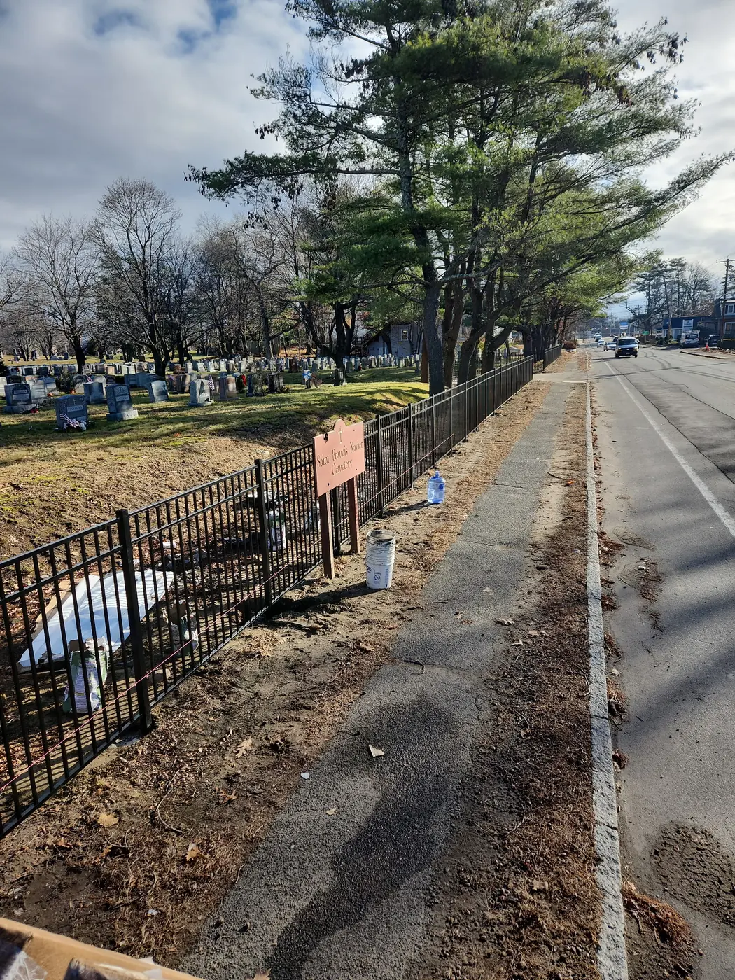 Black aluminum fence installed along the Saint Joseph Cemetery roadside