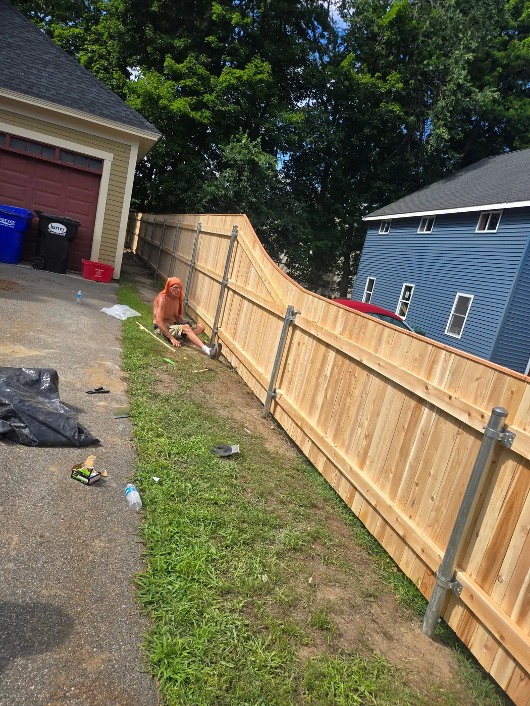 Custom cedar privacy fence following a sloped residential lot